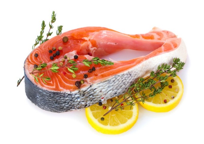 Red fish with lemon and thyme isolated on white.