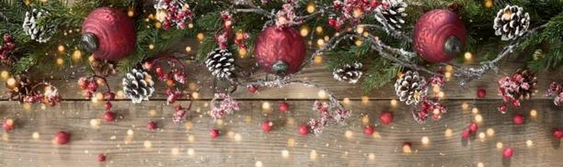 Christmas berry garland border on an old wood background